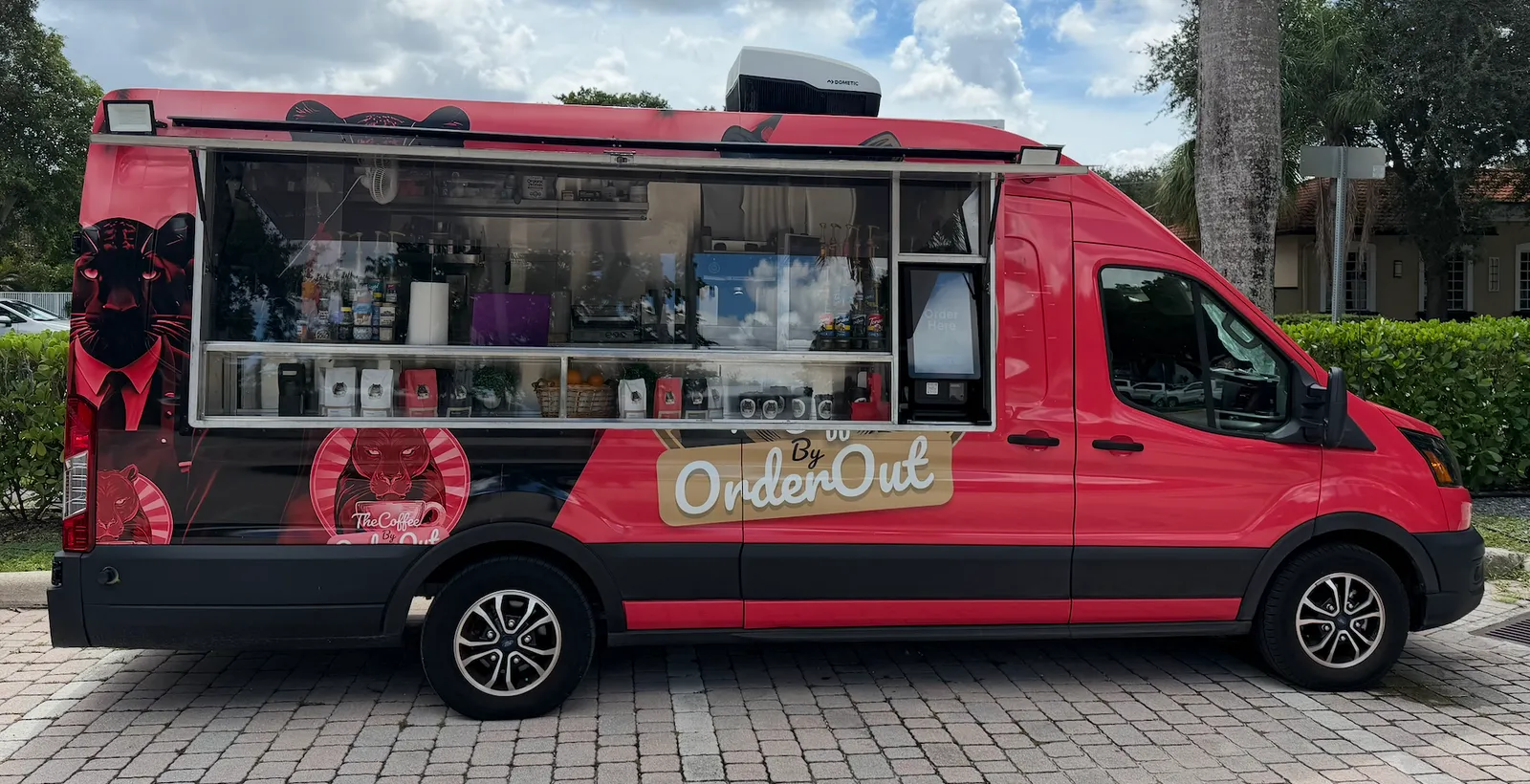 OrderOut Bites food truck, red with a panther logo, parked and serving coffee