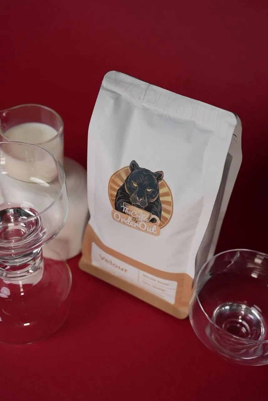Bag of OrderOut Bites Velour whole bean coffee, cream and gold packaging